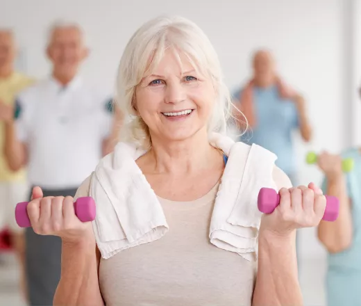 Active Older Adult with weights and towel